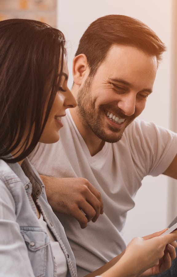 Couple looking at a tablet in their hands